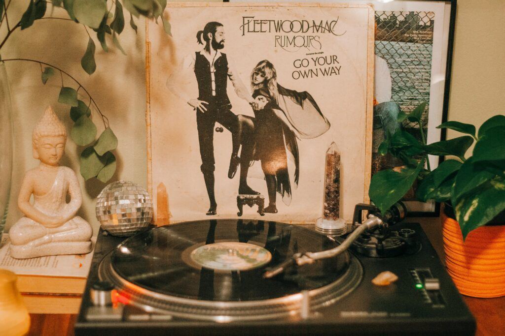 Cozy indoor scene featuring a vintage turntable and Fleetwood Mac Rumours album with decorative elements.