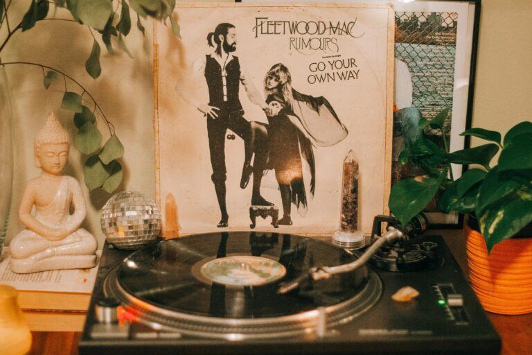 Cozy indoor scene featuring a vintage turntable and Fleetwood Mac Rumours album with decorative elements.
